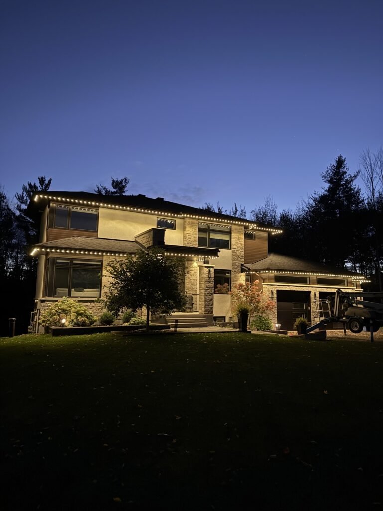 Ottawa home at dusk with warm white permanent LED lighting along the rooflines by House Homie